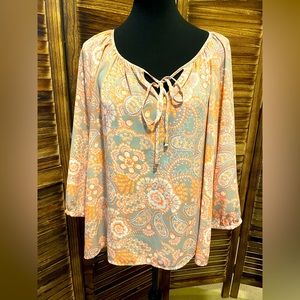 Very flattering top, gray and peach colored.